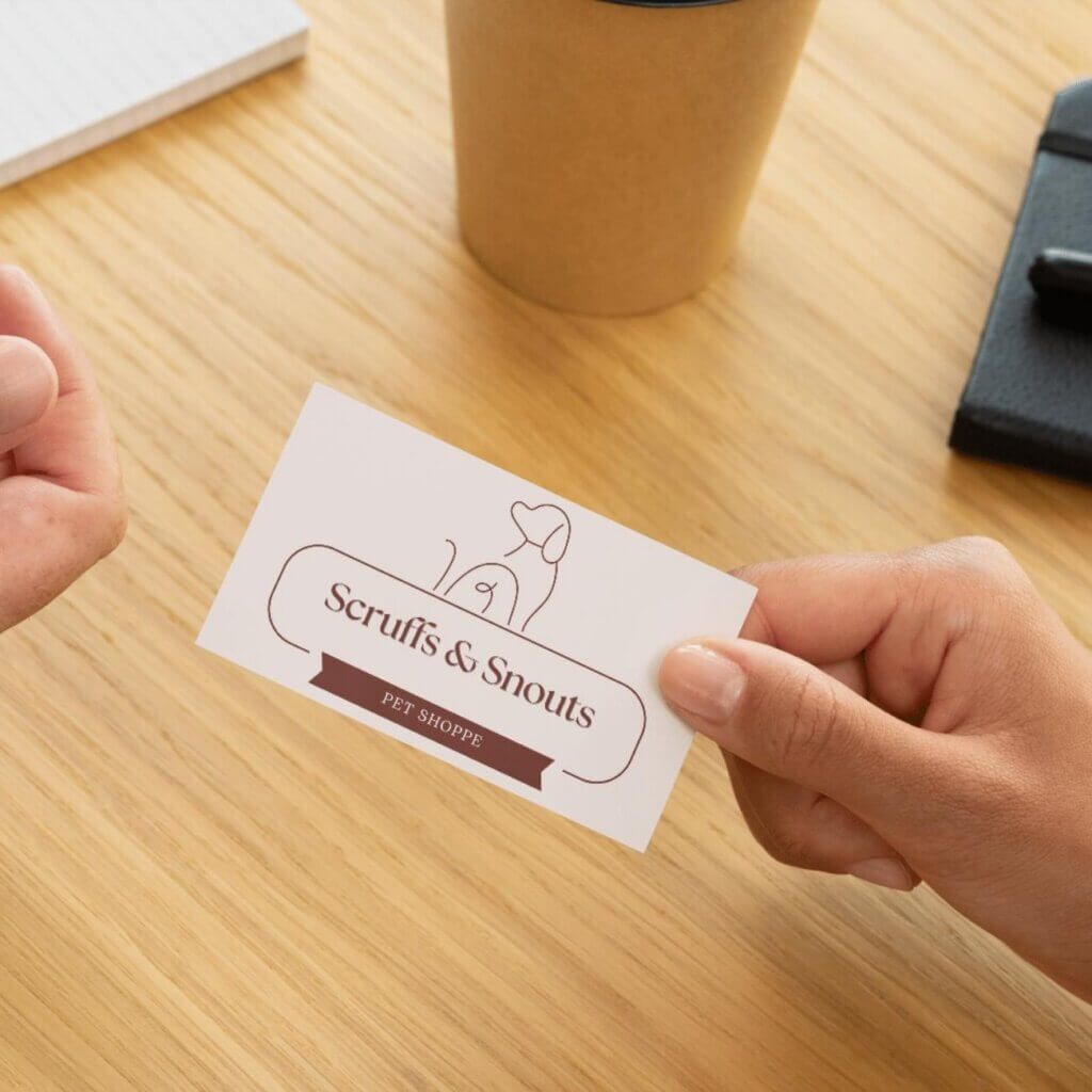 DIY logo printed on a business card held by a small business owner